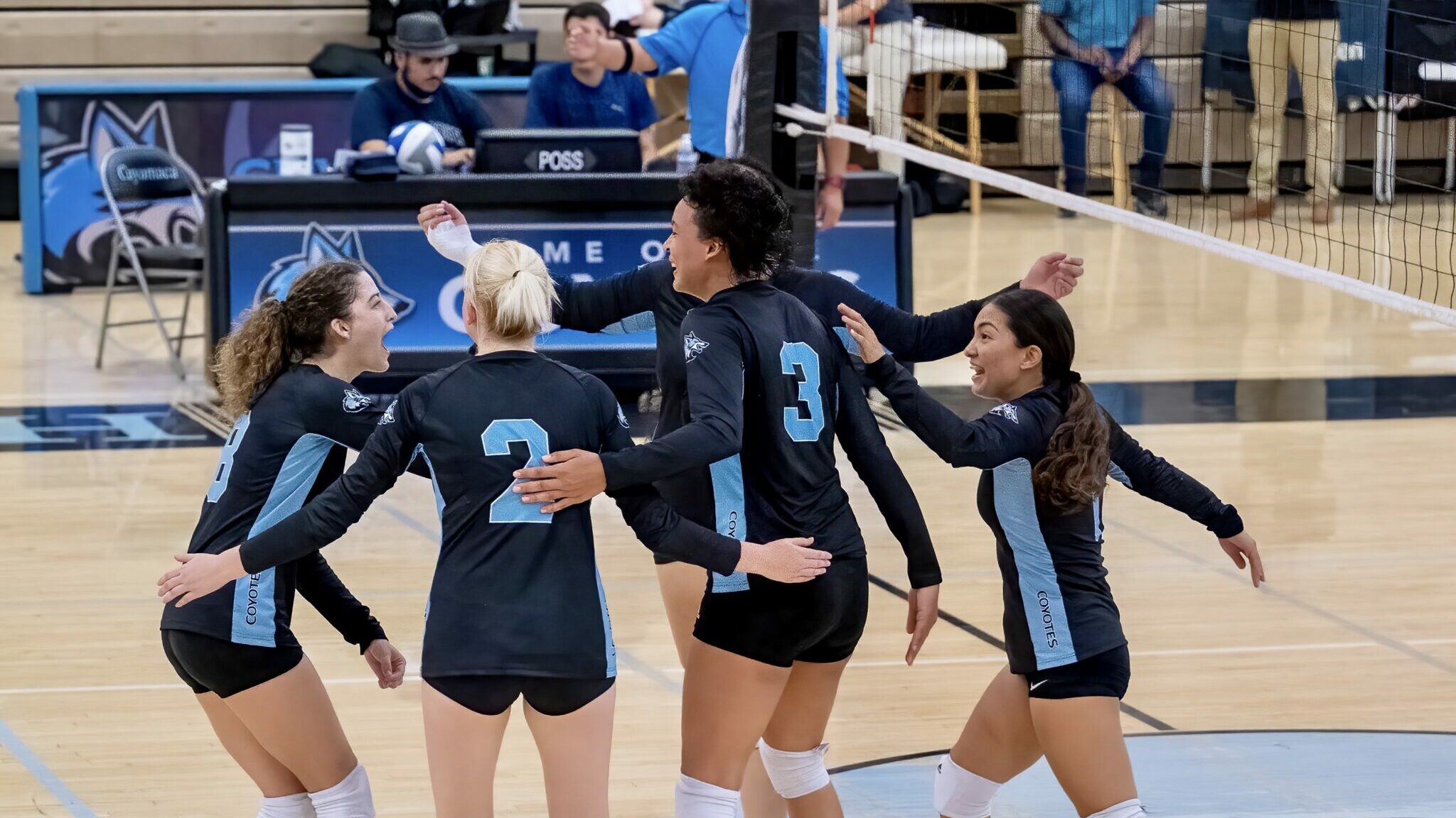 Cuyamaca College volleyball team celebrating on the court