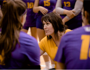 Woman coach chatting to volleyball team