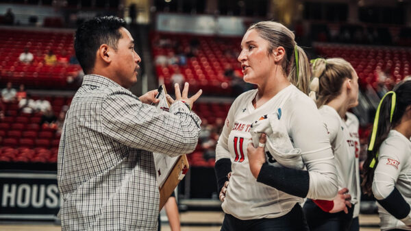 Jon Wong coaching an athlete on defense