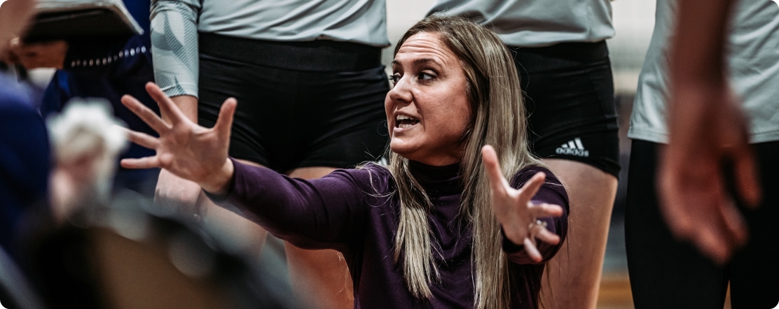 Volleyball coach instructs her team
