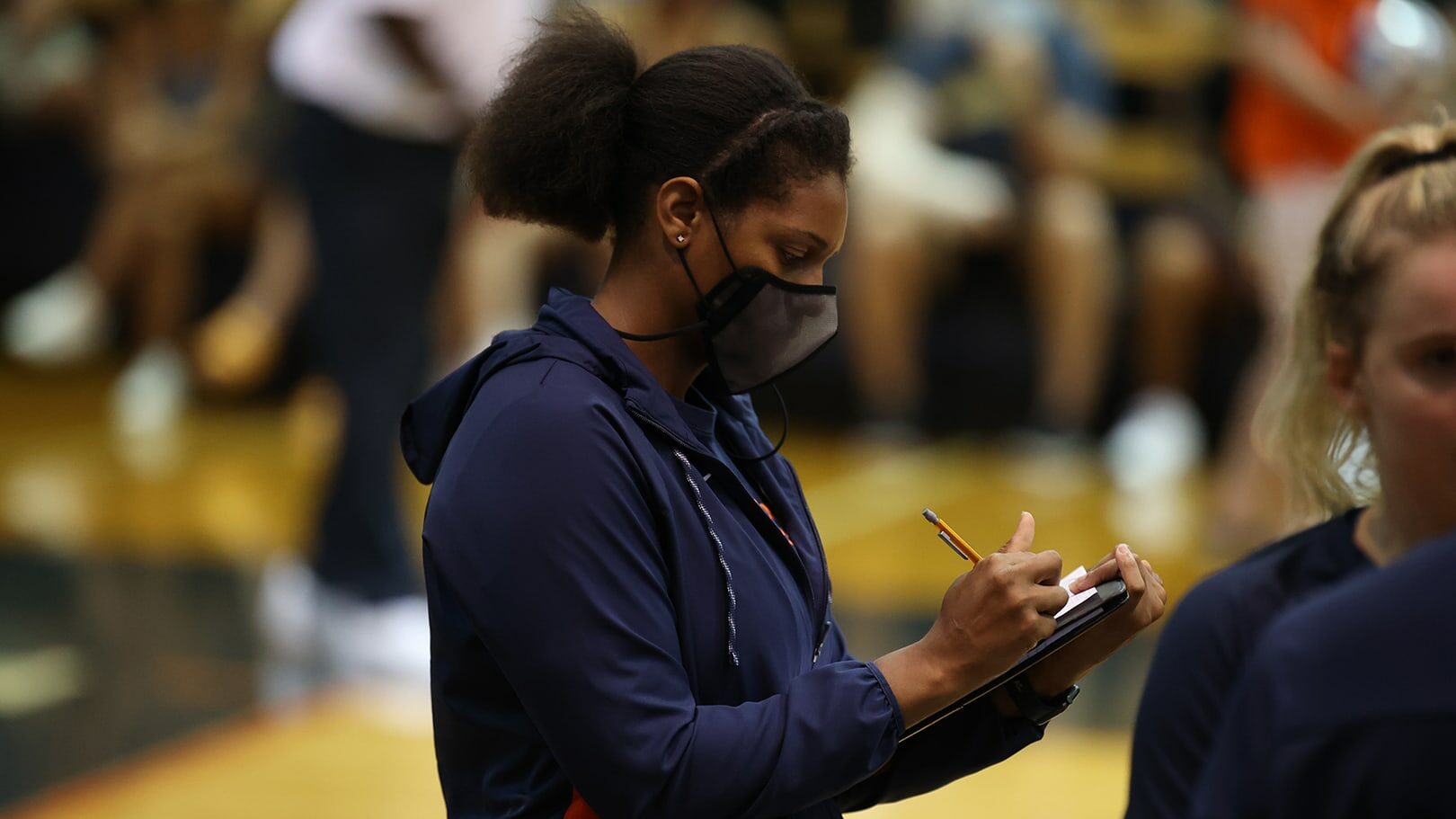 Nicole Miller writing notes at a match