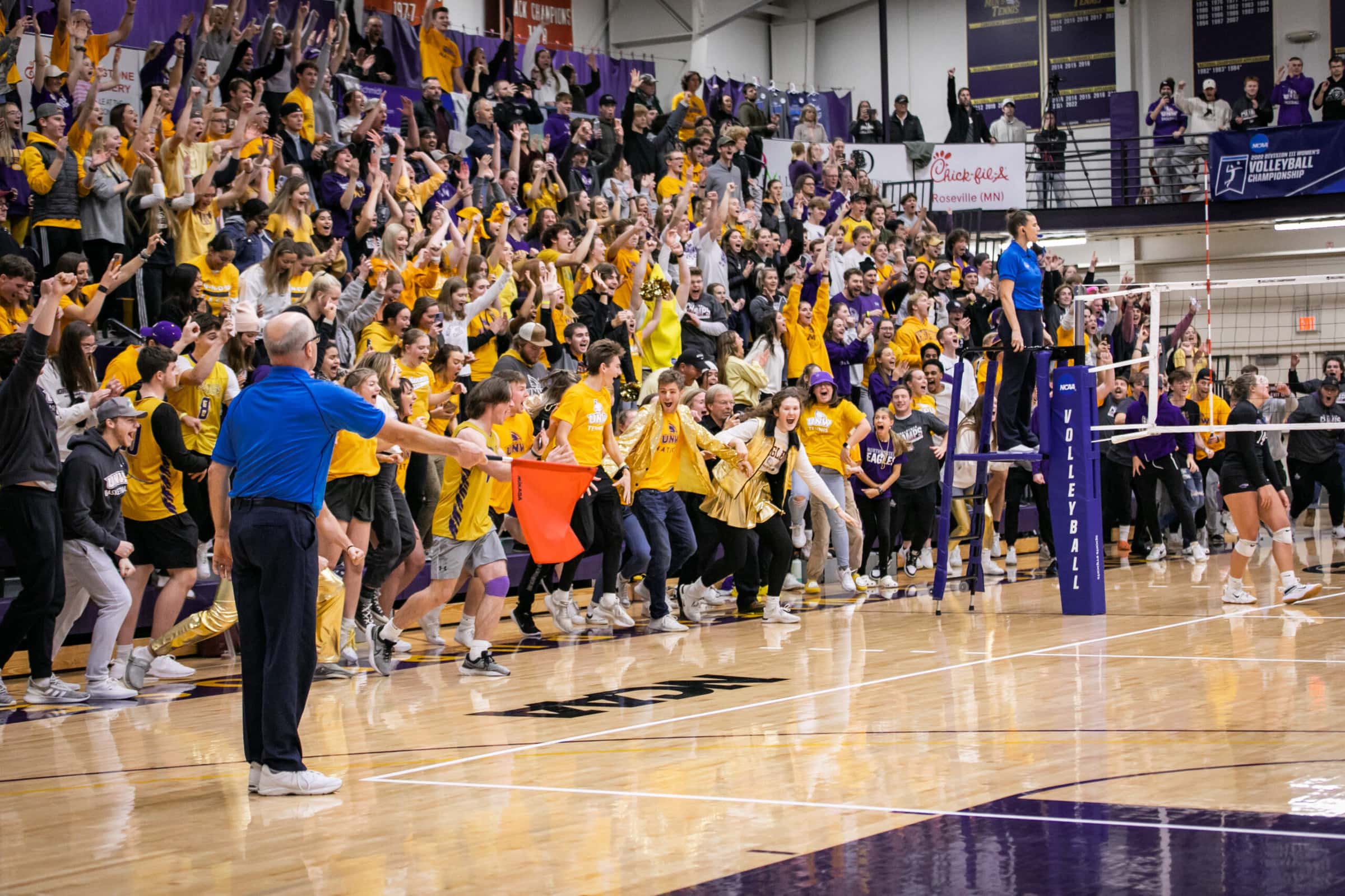Volleyball fans cheering, volleyball official making a call