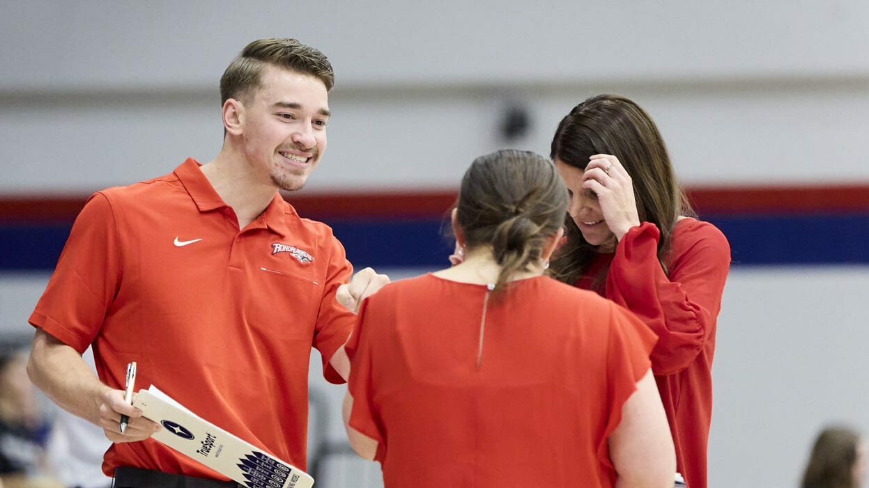 Three volleyball coaches discussing strategy