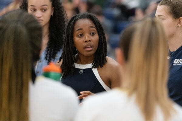 volleyball coach providing feedback to athletes in the huddle