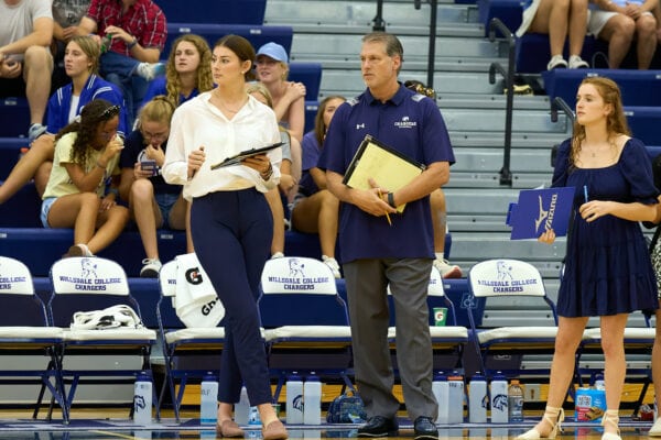 Coaches standing on the sideline during a match