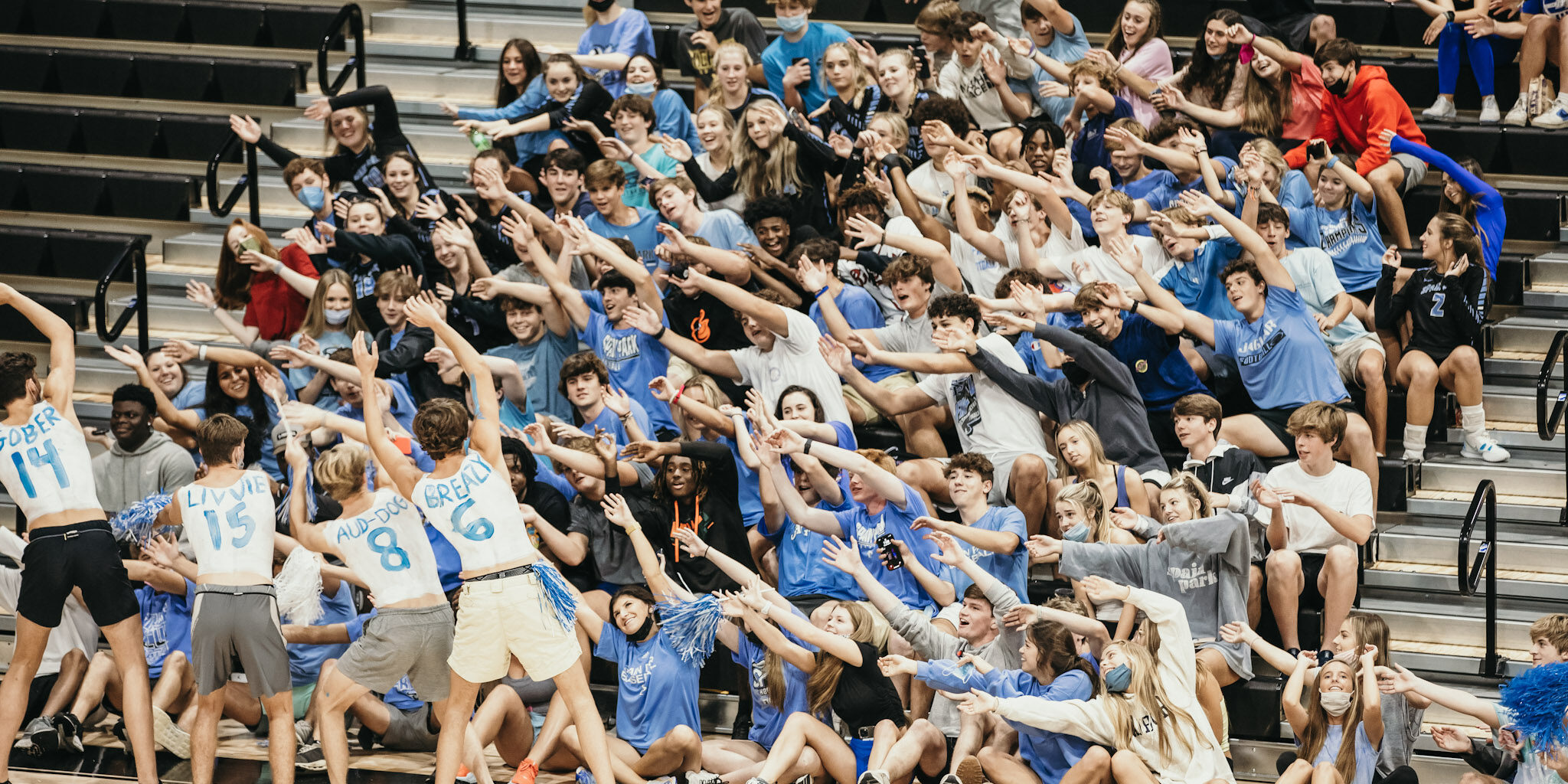 Fans at a high school volleyball match