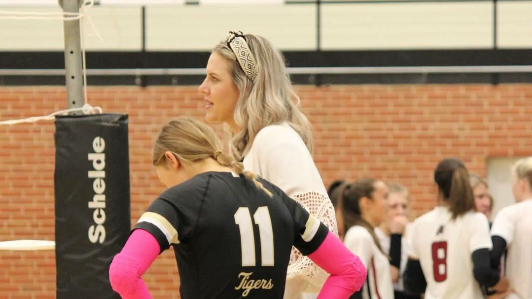 Volleyball coach talking to athlete