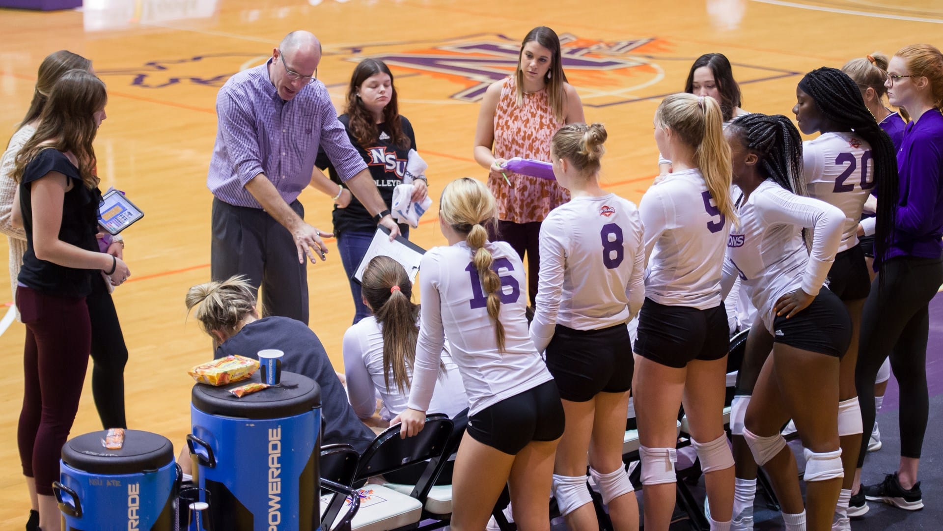 Coach talking to his team on the bench