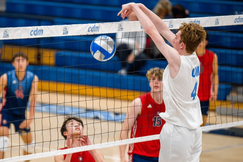 Brady Gant (4) of Corona del Mar tips the ball over the net against Beckman in a non-league boys volleyball game at Corona del Mar High School in Newport Beach on Friday, March 1, 2024. (Photo by Leonard Ortiz, Orange County Register/SCNG)