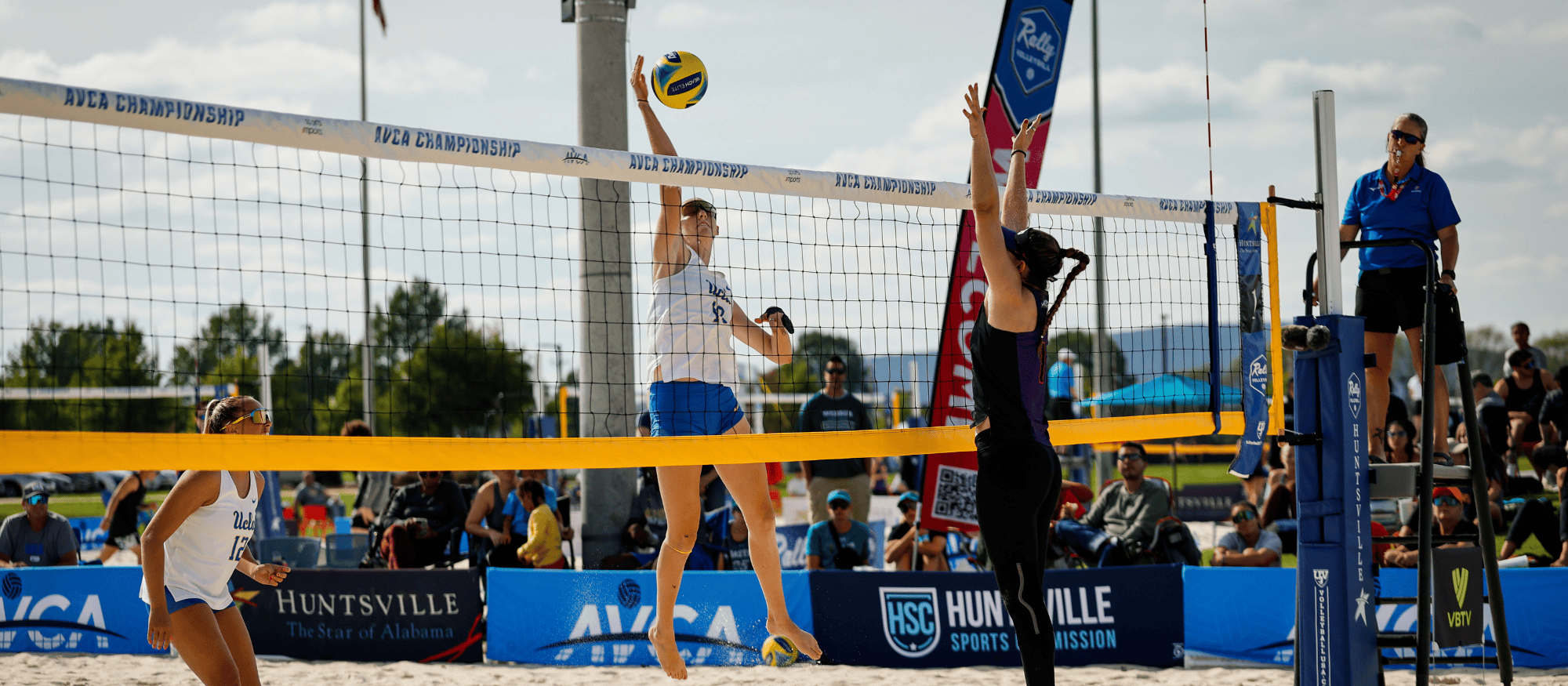 UCLA beach volleyball player attacking the ball