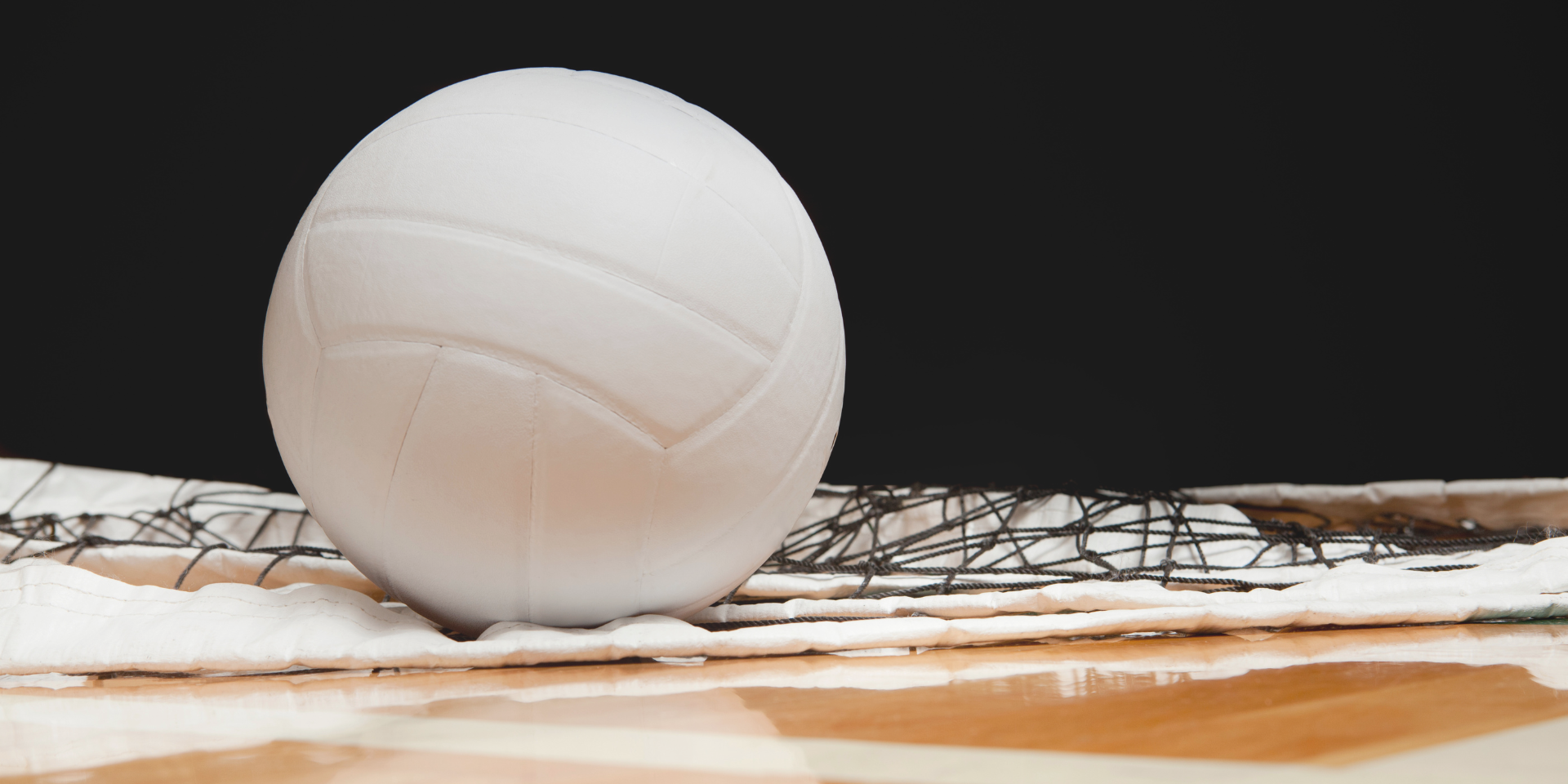 volleyball and net on the court, dark background