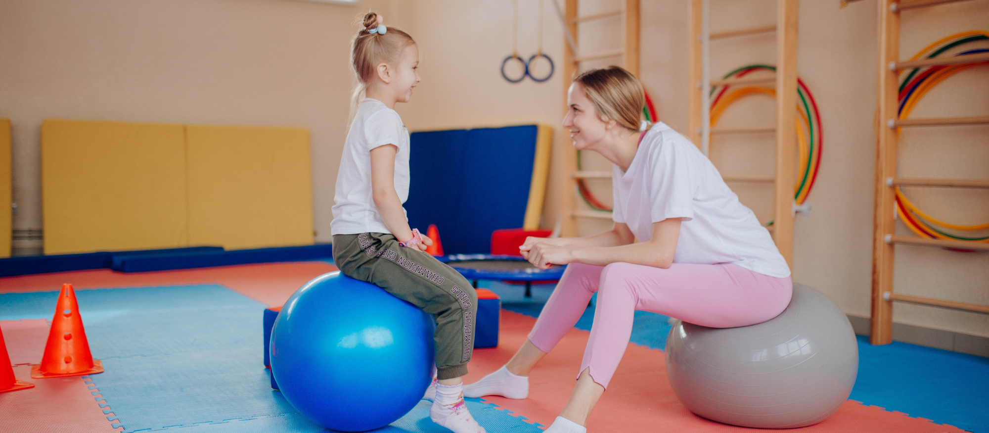 woman and girl sitting on exercise balls