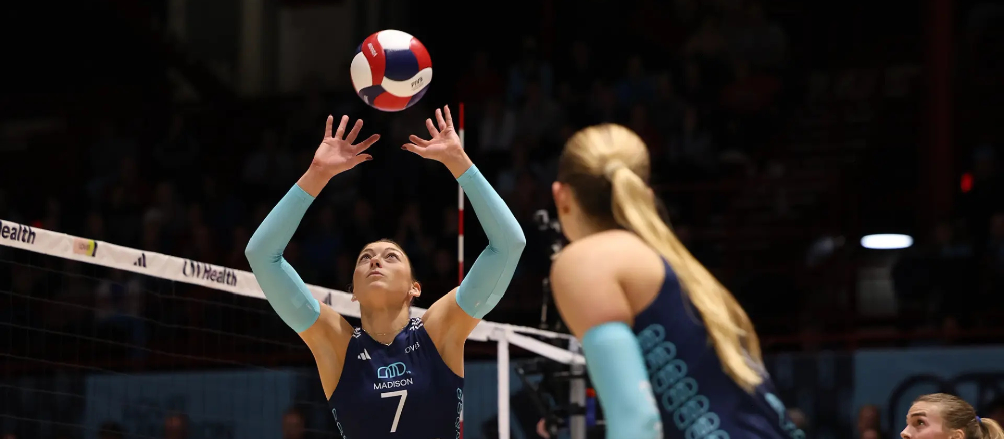Lauren Carlini setting a ball