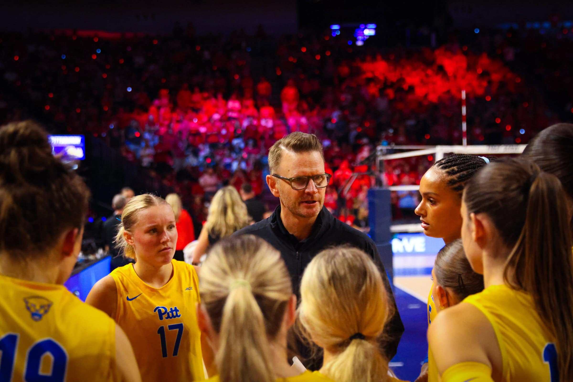 Dan Fisher talking to Pitt Volleyball Players in a huddle