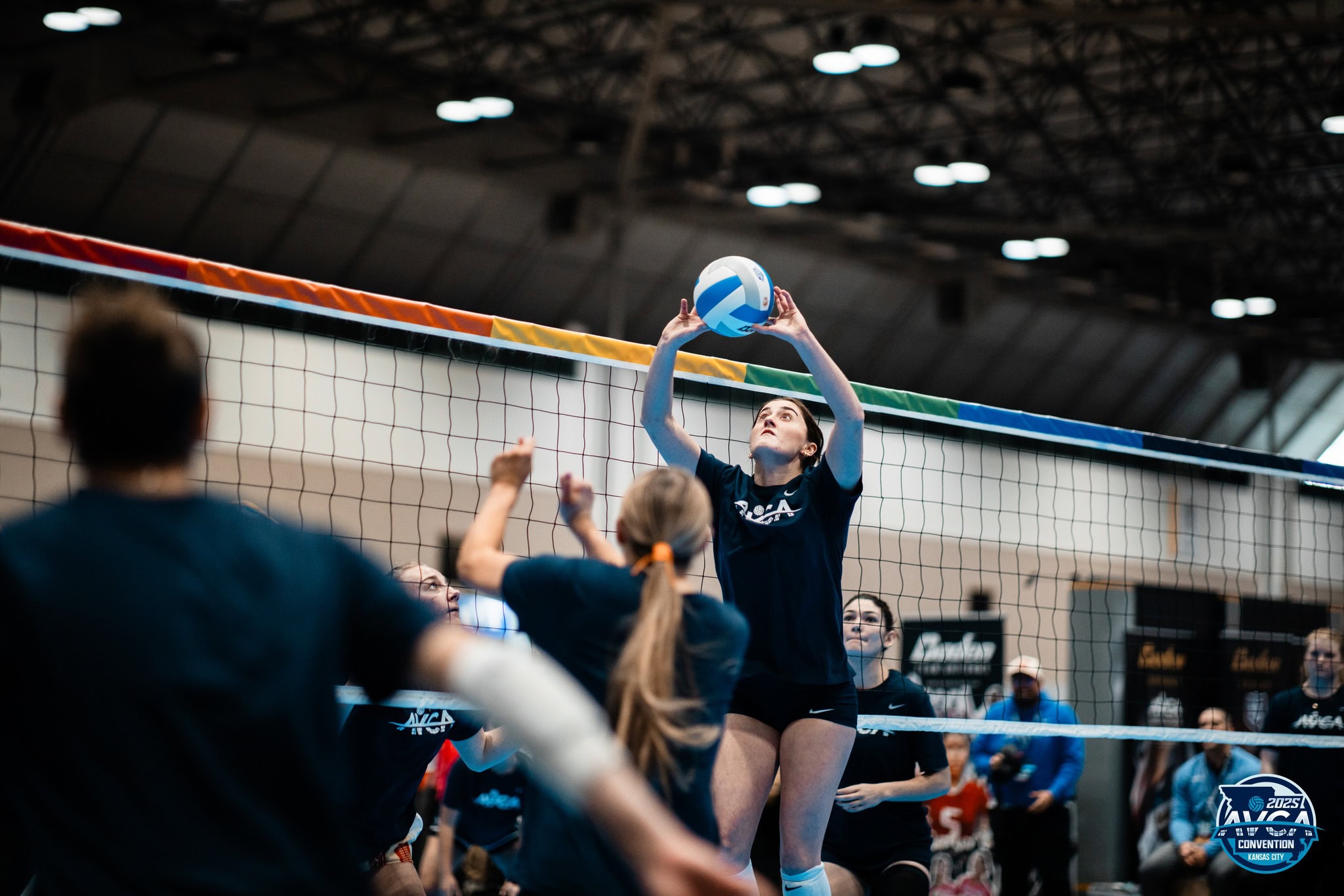 AVCA Convention demonstrator setting a middle