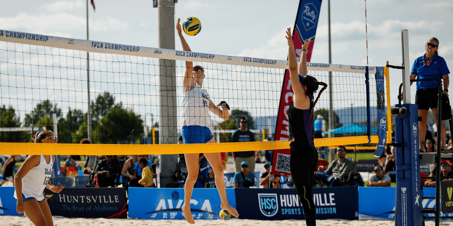 UCLA beach volleyball player attacking the ball