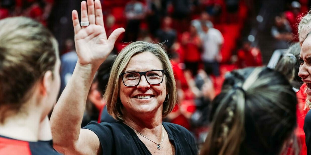 Beth Launiere with team high fiving athlete