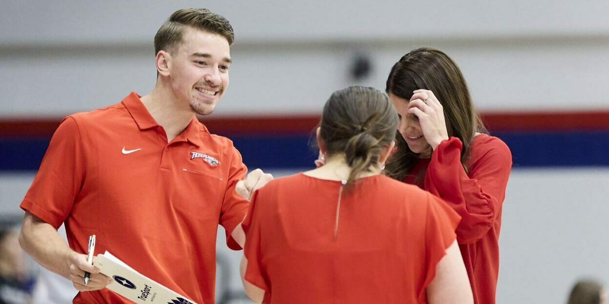 Three volleyball coaches discussing strategy