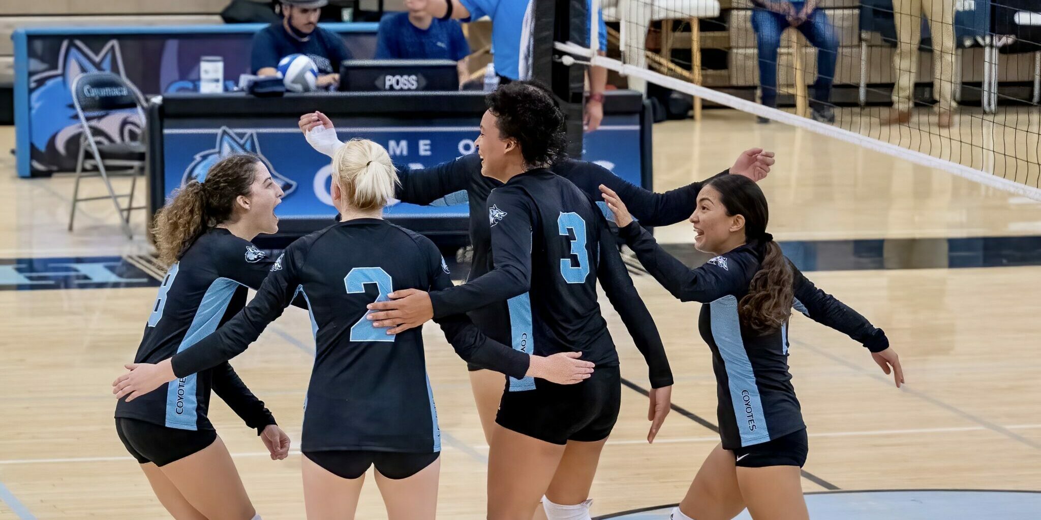 Cuyamaca College volleyball team celebrating on the court