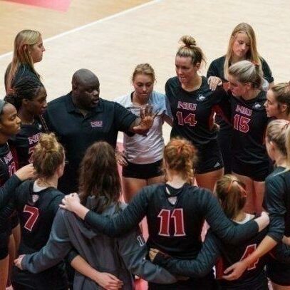 women's college volleyball team huddle